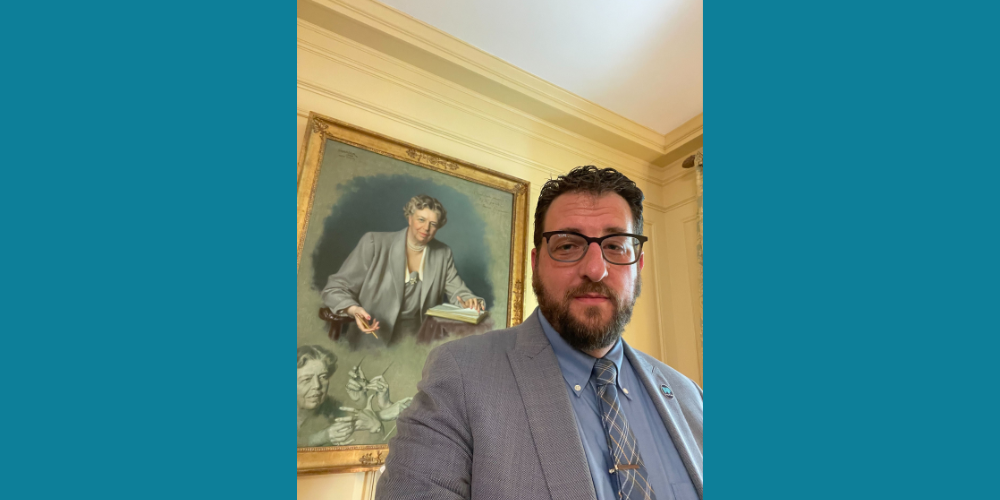 Free Press Co-CEO Craig Aaron in front of the Eleanor Roosevelt portrait at the White House